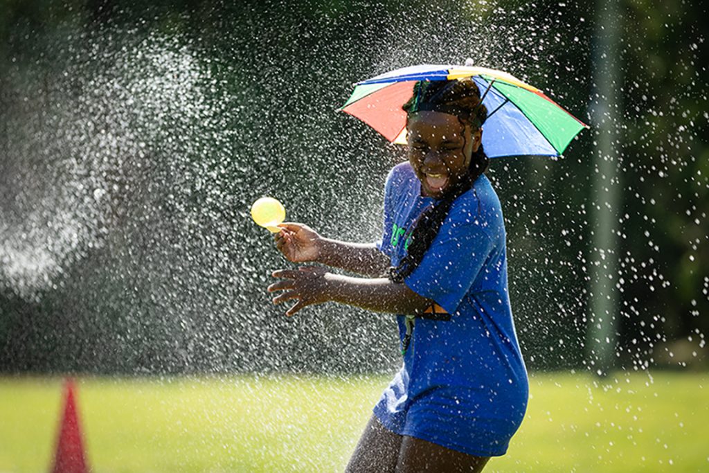 Kids College student carrying balloon on a spoon