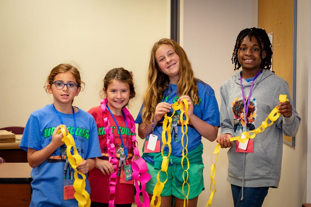 Kids College students holding craft