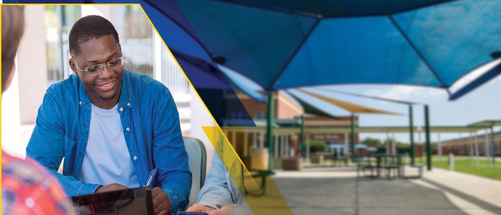 Students collaborating in a group with laptops