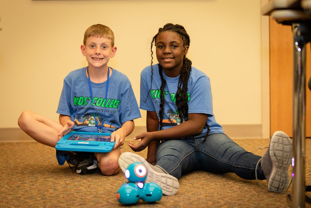 Students Kids College playing with robot