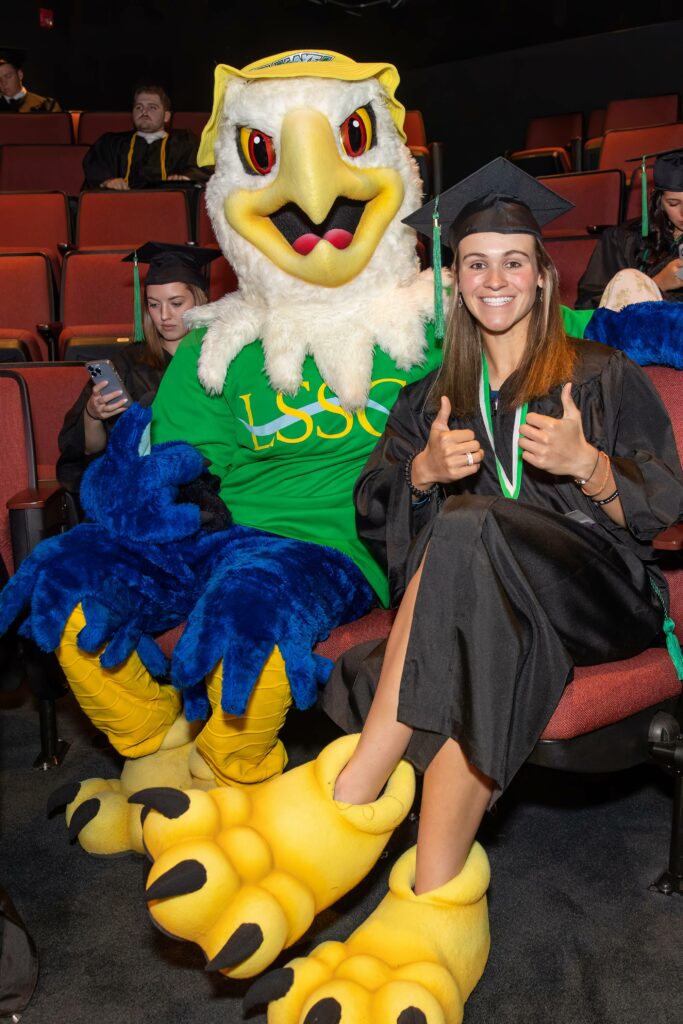 Makenzi Heaton poses with Swoop feet on next to LSSC's mascot, Swoop