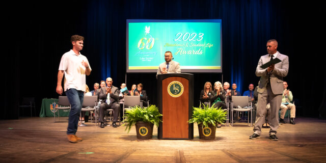 Laura Hasty award recipient, Ryan Monaghan walks across the stage to receive his award at the 2023 Academic & Student Life Awards ceremony.