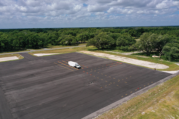 Aerial photo of paved parking lot with semi truck parked in center