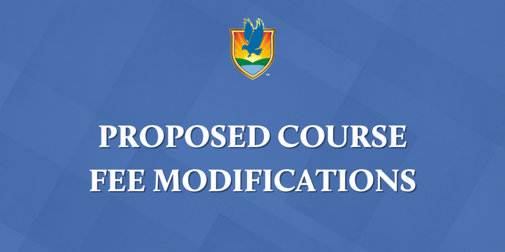 Group of individuals on stage holding awards at event, with plants and flags in background.