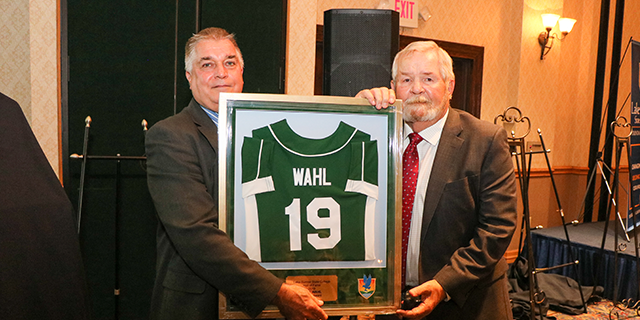 Pete Wahl and Dr. Sidor standing with Mr. Wahl's award frame