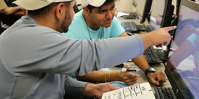 students working together in front of a computer