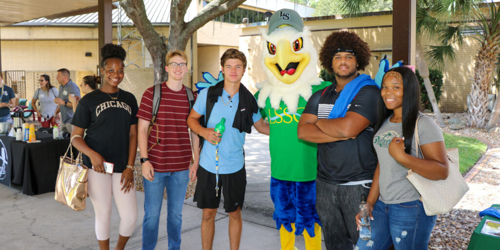 Students pose for a photo with Swoop the Lakehawk in the middle