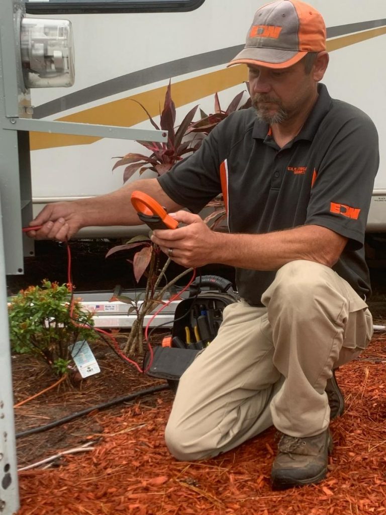 Electrician performing testing on outside equipment