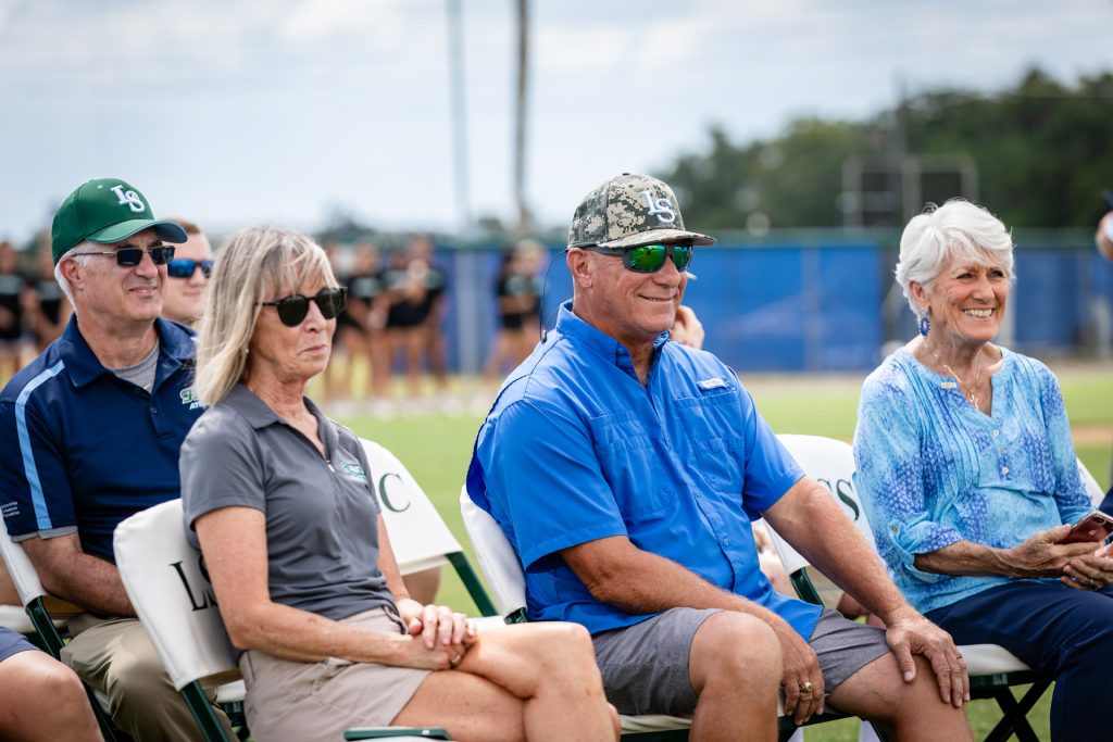 Coach Mike Matulia, his wife Betsy, and mother watching LSSC baseball game,