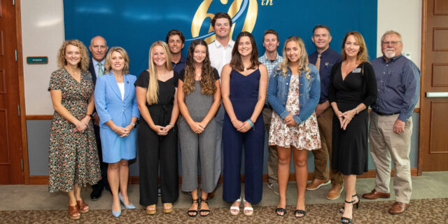 student-athletes pose for a photo with LSSC District Board of Trustees members and President Heather Bigard