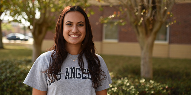 SGA President Angelica Ceron poses in front of a building on LSSC's South Lake Campus