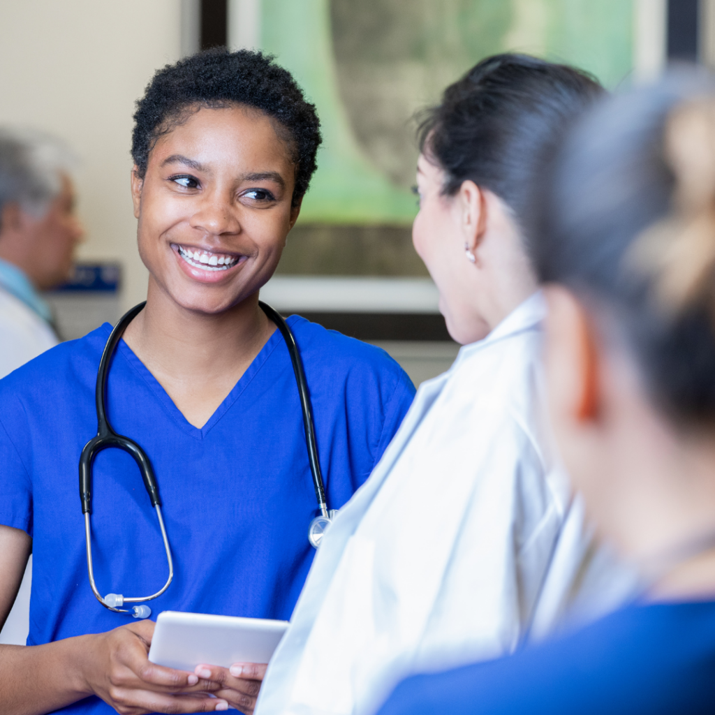 A nurse smiling at a provider