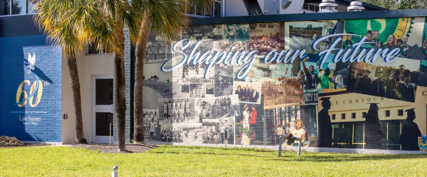 Colorful mural, historic photos, "Shaping our Future," brick wall, 60 years Lee College celebration. No individuals shown.