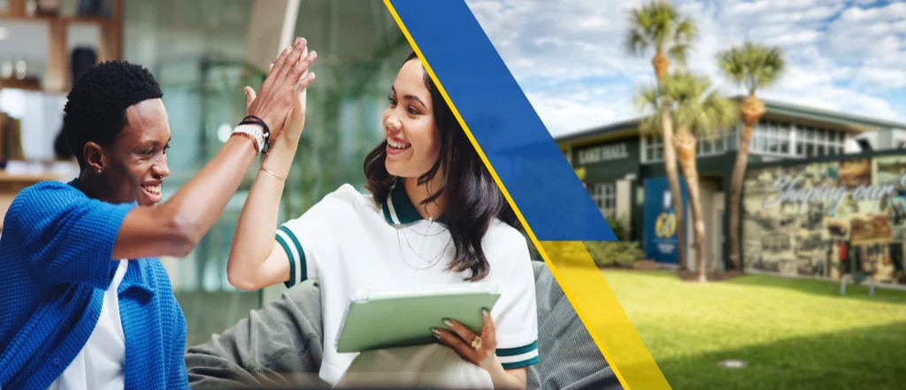 college students high five with tablet in library