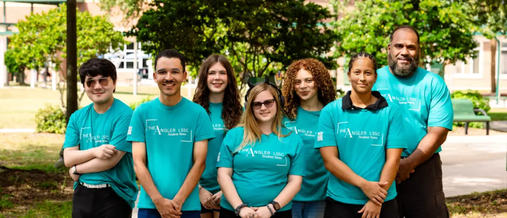 Six individuals in turquoise The Angler LSSC Student News t-shirts on a campus walkway.